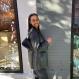 Sagal smiling outside in front a wall